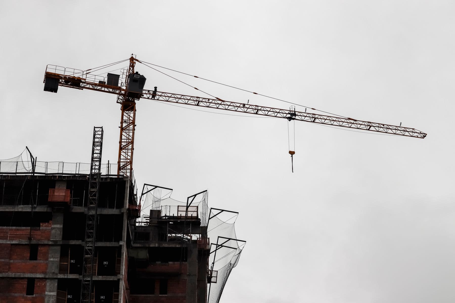 High-rise building under construction with a tower crane