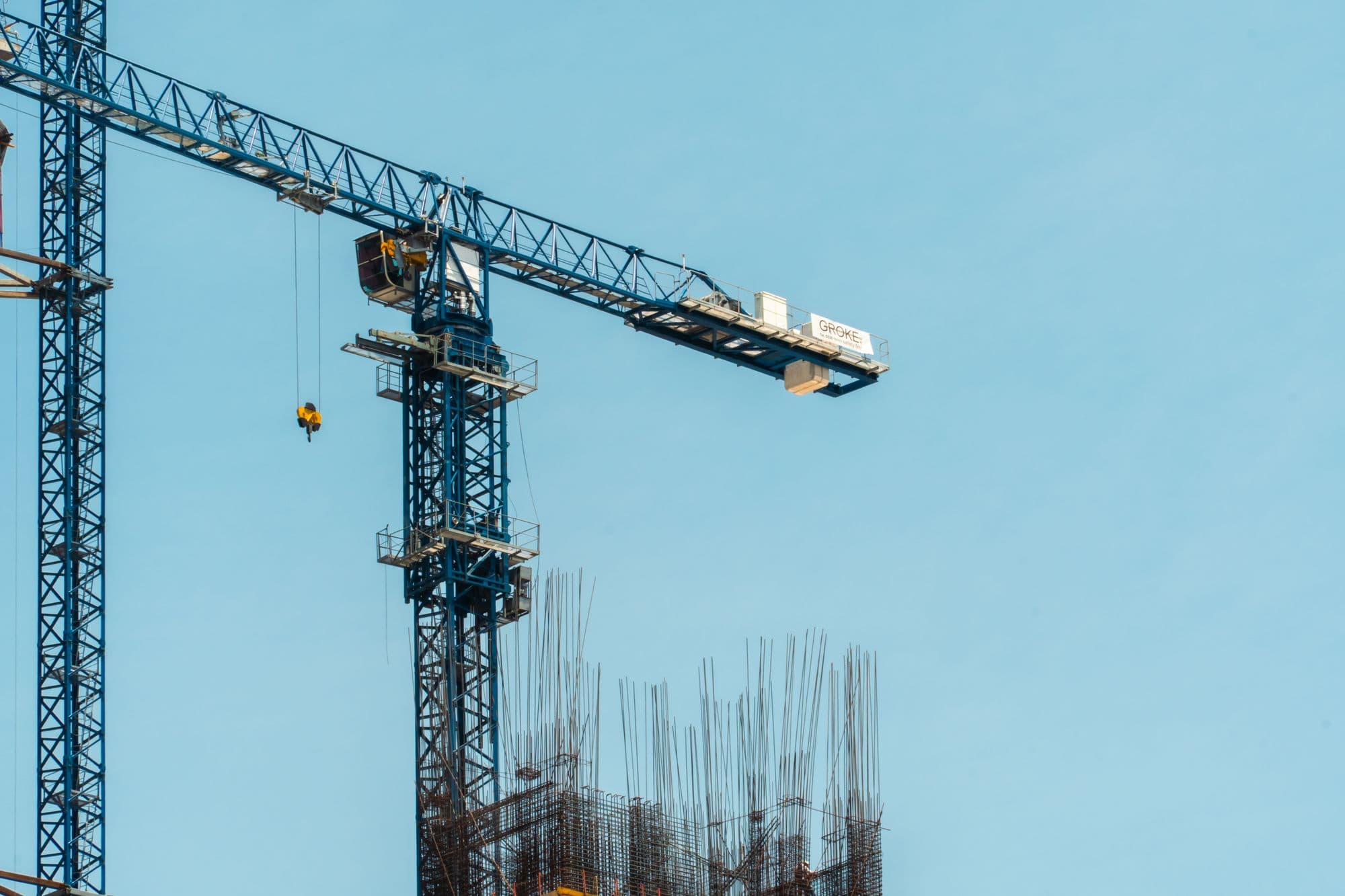 Tower crane on a major construction site against a clear sky